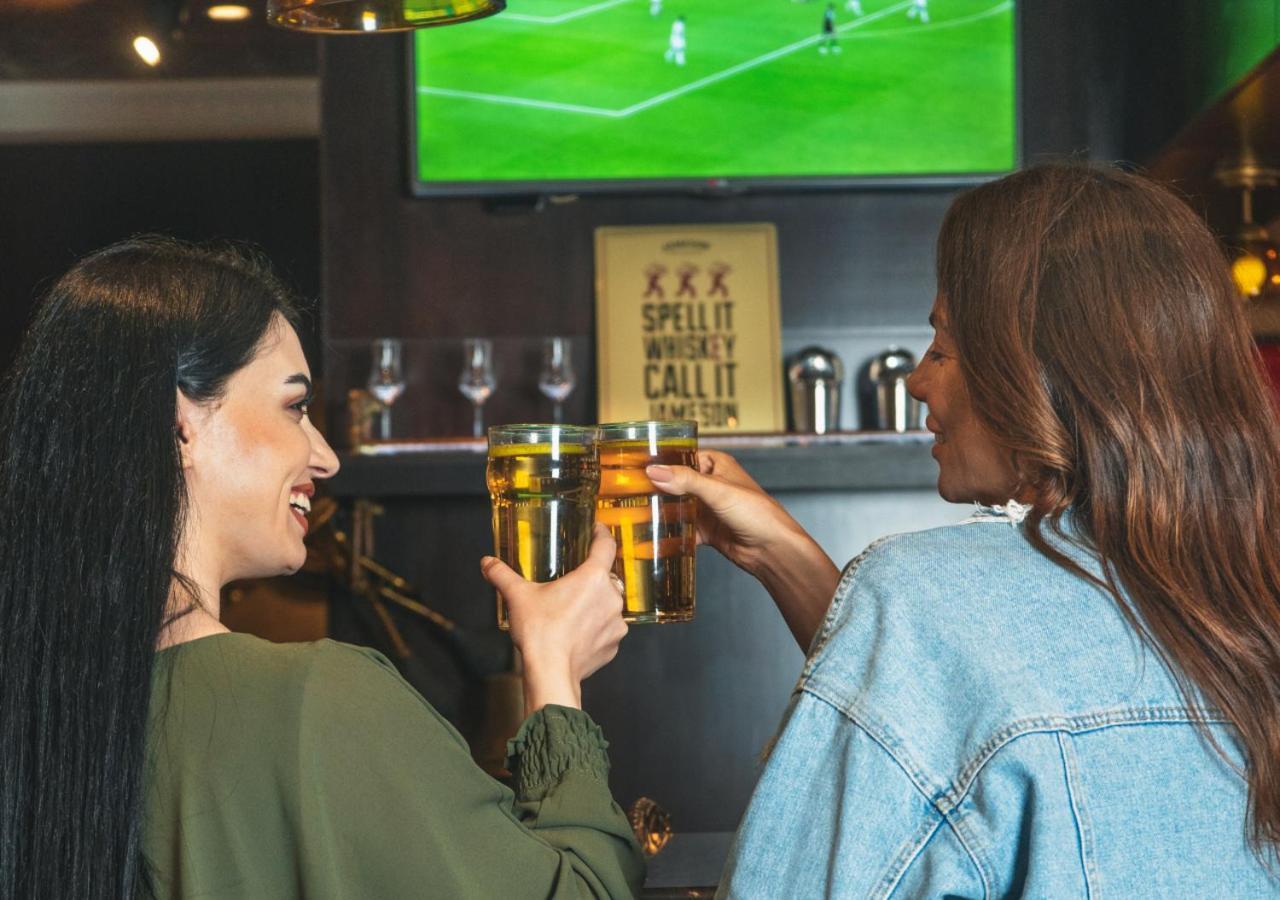 City Centre Rotana Doha Bagian luar foto Two women drinking beer