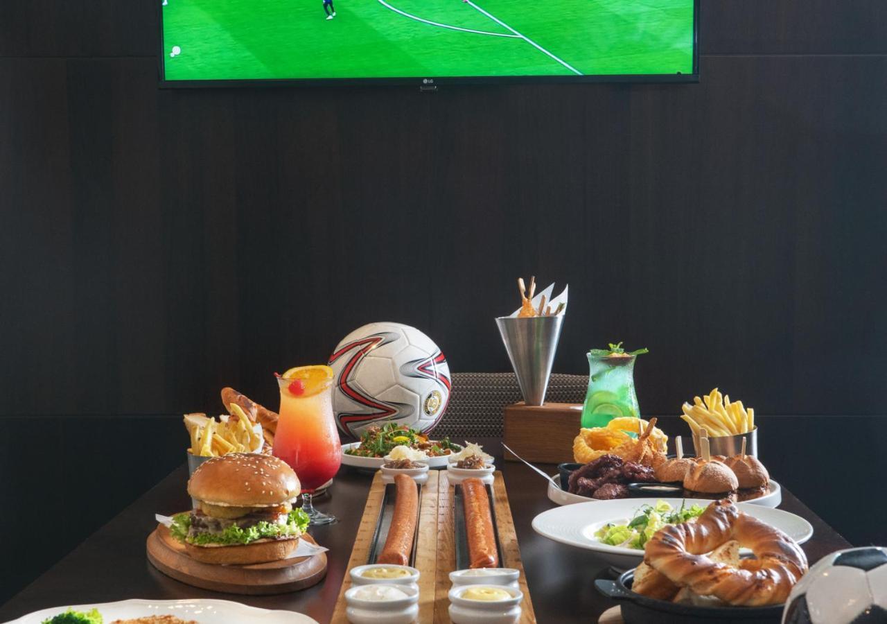 City Centre Rotana Doha Bagian luar foto A typical sports bar menu